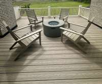 Entertain on this spacious sundeck, accessible from 2nd floor Bonus Room - Inspirational photo of fire pit and seating.