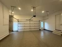 Bright and spacious4 - car garage to store your cars, tools and toys.  Epoxy flooring, high ceilings plenty of space for car lifts, wall storage, cabinets, side and rear pedestrian doors.