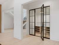 View of Wine Room with Custom Iron door and wine/wet bar.