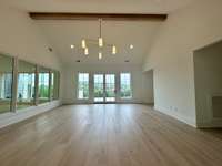 Beautiful Bonus Room with vaulted ceiling, windows looking over great room and egress to fabulous  sun deck.