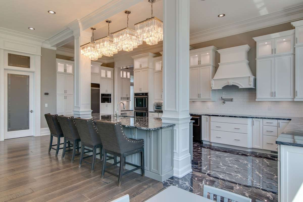 All of the kitchens feature impeccable style with gleaming white cabinetry which contrasts beautifully with the marble floors, granite counters and black stainless appliances.