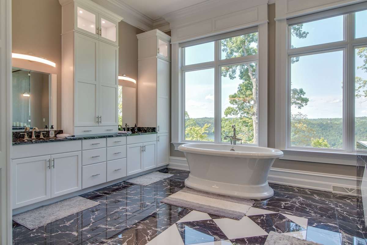 The owner's bath feels like a spa.  With an ornate stand alone tub, marble floors and crisp white cabinetry, it makes for a beautiful and ultra-functional space.