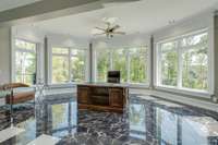 Here you'll find a marble-floored office flanked by floor-to-ceiling windows.