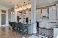 All of the kitchens feature impeccable style with gleaming white cabinetry which contrasts beautifully with the marble floors, granite counters and black stainless appliances.