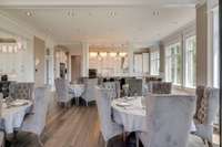 There's room for several tables in the main-level dining room.  Imagine hosting incredible events in this stunning home.