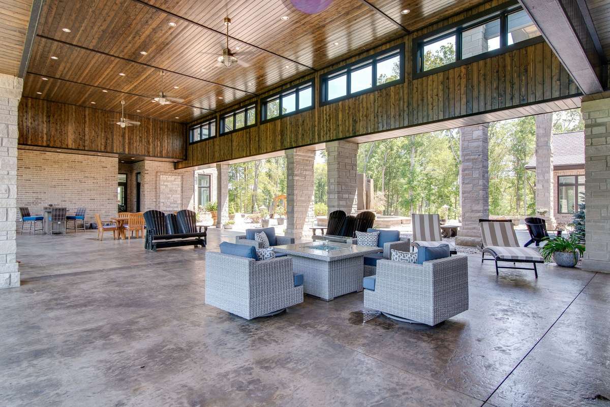 One of the most impressive outdoor spaces is this 2-story high resort-styled breezeway which connects the main house to the office wing.  Relax in the shade while enjoying more amazing views of the lake from here.