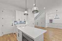 Clean, white cabinets and quartz counters.  Lots of cabinets.