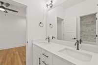 Nice Jack and Jill bath with double vanities.  Shower/tub combo