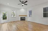 Spacious family room has lots of natural light and corner fireplace, ceiling fan.