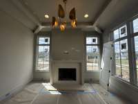 Study with fireplace, lots of windows, coffered ceiling, custom iron doors and large storage closet    *this home is under construction    Photo taken: 4/4/24