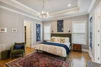 11' tray ceiling, recessed lighting, sconces and contemporary chandelier create a sense of calm....