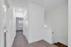 Upstairs View. 2 Bedrooms behind this shot, Full Hall bath on left, Tiled Laundry on Right, Primary Suite straight ahead. (Photo is of previous Townhome built. It is the same floor plan, but interior finishes may vary).