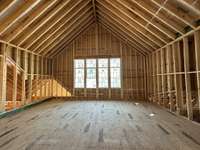 Huge Bonus Room with vaulted ceiling and wet bar  *this home is under construction  Photo taken 1/11/24