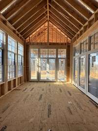 Breakfast room with a vaulted ceiling, lots of windows  *this home is under construction  Photo taken 1/11/24