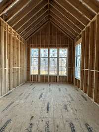 Primary Bedroom with vaulted ceiling, lots of natural light on main level  *this home is under construction  Photo taken 1/11/24