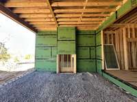 View of Covered Living area with Fireplace  *this home is under construction  Photo taken 1/11/24