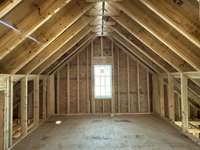 Playroom with vaulted ceiling that adjoins Bunkroom  *this home is under construction  Photo taken 1/11/24