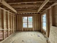 Bedroom 5 featuring walk-in closet and full bath *this home is under construction Photo taken: 1/8/24