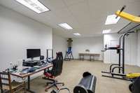 Basement is a workout haven with plenty of room for some workspace as well!