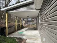 Fully covered back patio with access to side driveway and back door entry to dining area.