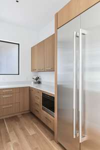 Sleek appliances and more storage lead you to the pantry / bar area.