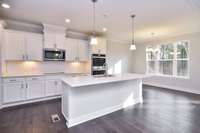 Spacious Kitchen/Casual Dining Area. Large Pantry and Island. Photo is of a similar floor plan, not actual home.