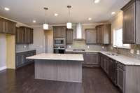 Spacious kitchen with lots of cabinets. Photo is of a similar floorplan, not actual home.