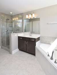 Separate shower in Owner's Bath. Photo is of a similar floorplan, not actual home.