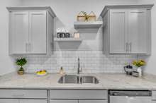 Custom Floating Shelves above sink & Tiled Backsplash. (This home is similar to the home under construction. Selections may vary, please see listing media for details).