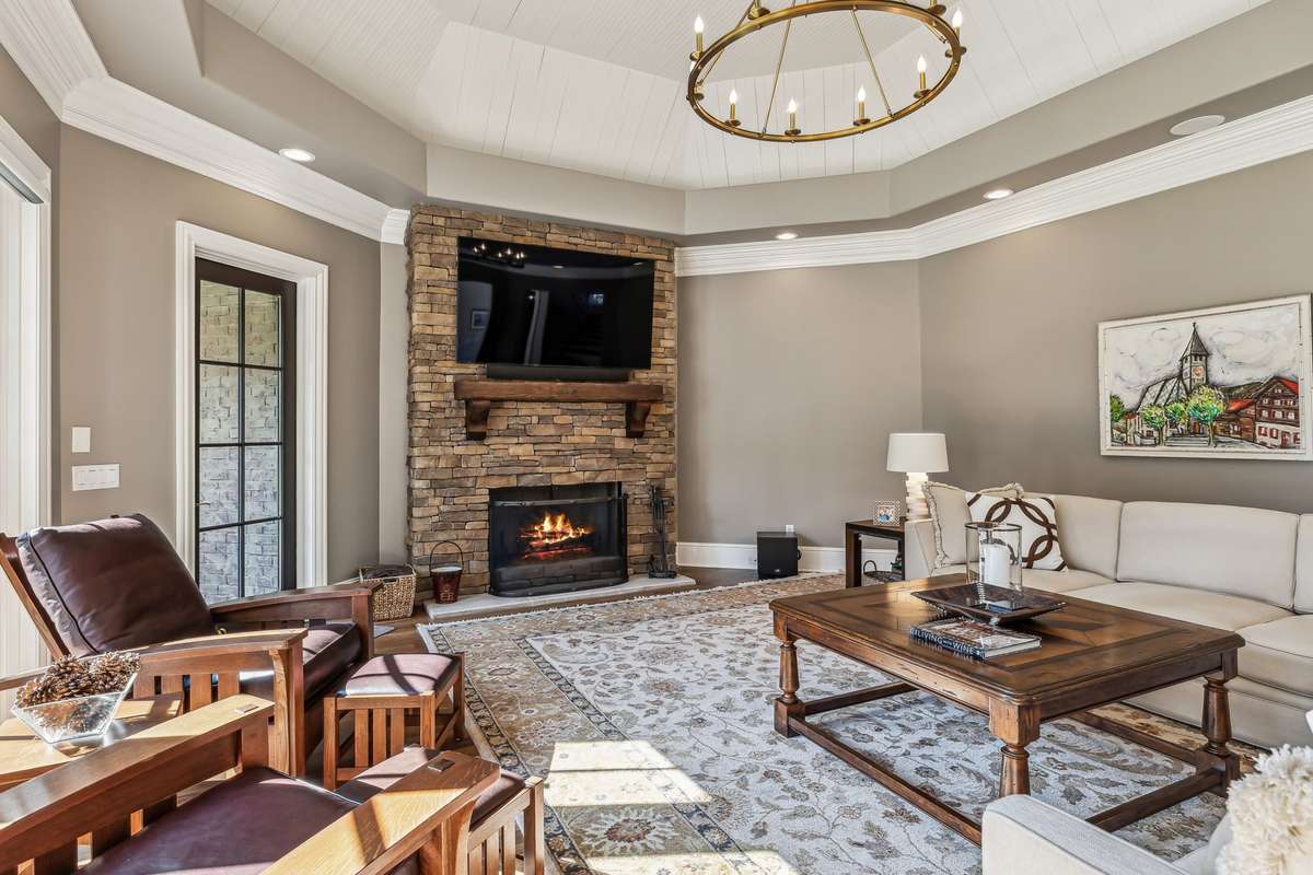 The Family Room is a spacious retreat, perfect for entertaining. Framed by sweeping views of the lush backyard & mature trees beyond, this room is bathed in natural light from multiple windows & a glass door that opens to the covered porch.