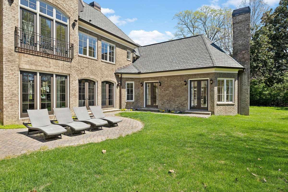 Step outside to the Uncovered Patio, where mature landscaping surrounds you, creating a serene retreat. The cobblestone paver patio, with vibrant flower beds, is the perfect place to relax, while decorative downspouts add a touch of style.