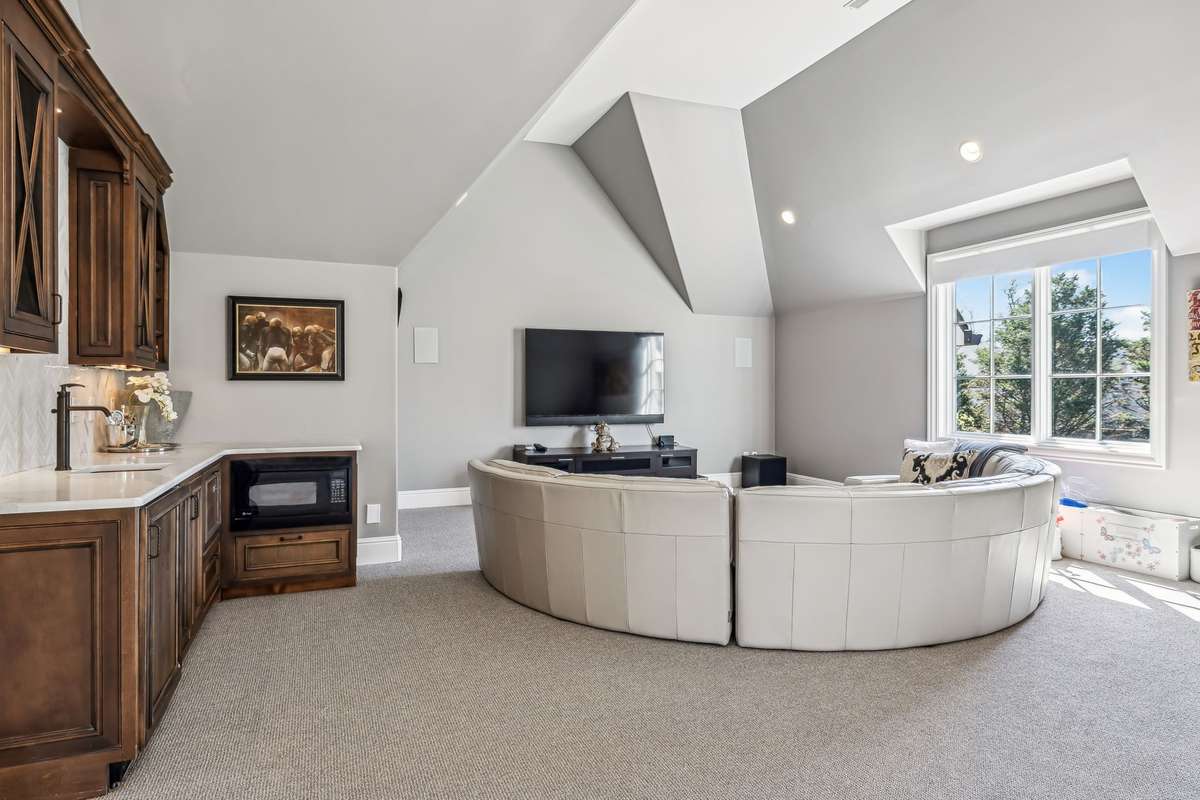 For the ultimate viewing experience, the room is equipped with a surround sound system, featuring custom sound bars and subwoofers, delivering crisp, immersive sound for streaming music and TV.