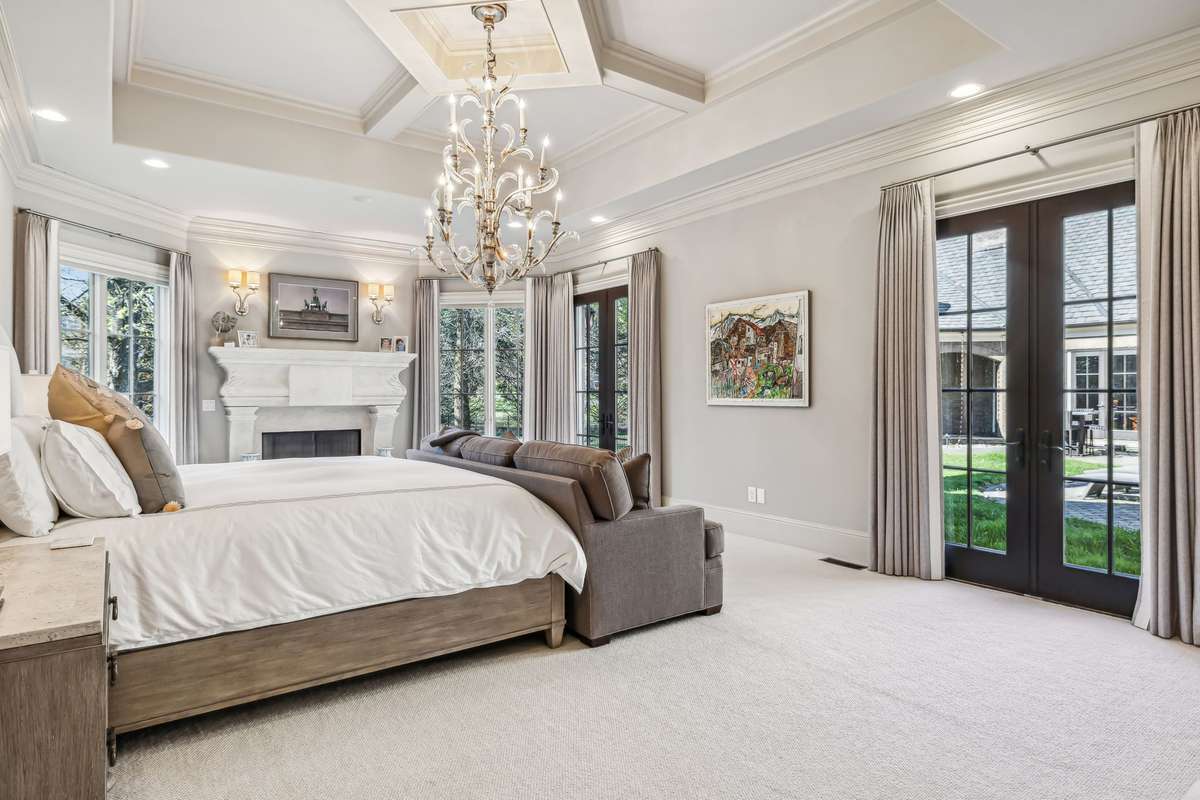 The Main Level Primary Suite is a luxurious haven for ultimate comfort & quiet indulgence. Bathed in natural light from large windows & two sets of French doors that open to the courtyard, this retreat blends elegance w/serenity at every turn.