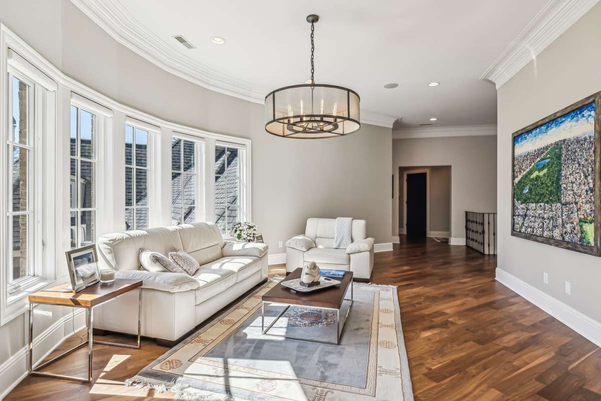 A perfect spot for a Sitting Area or a Homework Station, bathed in natural light large windows and a stylish metal chandelier - featuring a linen closet, a storage closet, a spacious game closet, and convenient access to the Elevator and Powder Room.