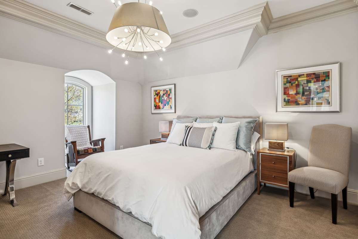Bedroom #5 offers versatile functionality, making it an ideal space for a guest bedroom, home office, or creative retreat. It features plush Berber carpeting layered over a cushioned memory foam pad, a unique light fixture, and a cozy alcove.
