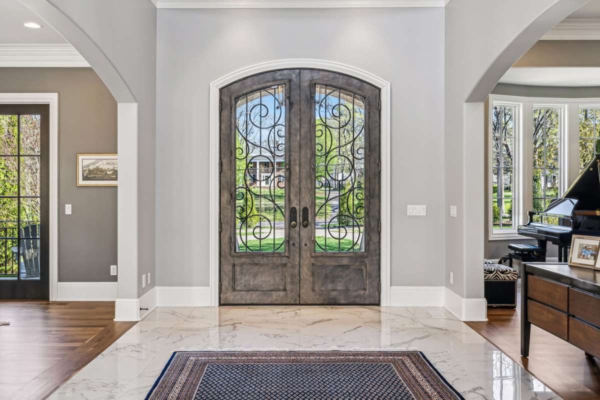 From the moment you step through the arched double iron doors into the breathtaking two-story Grand Foyer, you're enveloped in a sense of timeless elegance and grandeur.