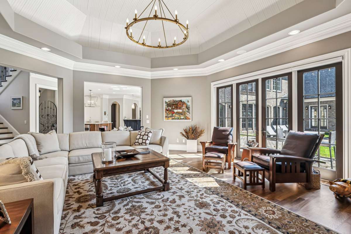 Additional touches of character include a bronze chandelier that adds a soft, ambient glow and a beadboard tray ceiling that brings texture and architectural interest to this beautifully designed room.