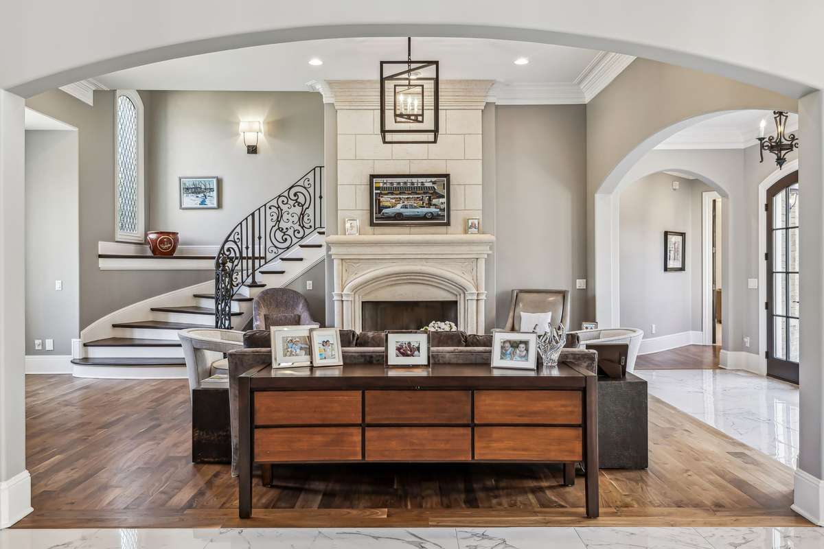 Flowing seamlessly from the Grand Foyer, the open Formal Living Room is a stunning showcase of light, elegance, and architectural charm.