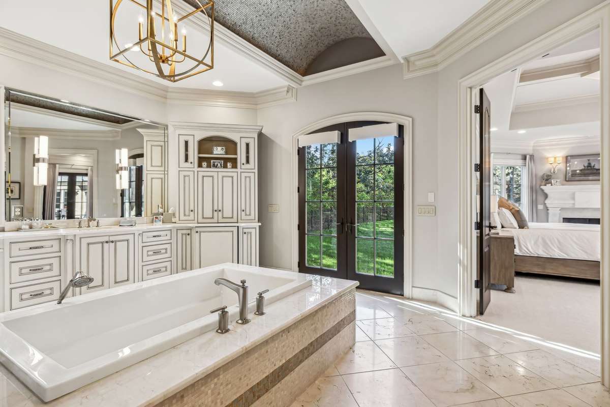 A gold chandelier, two water closets, two walk-in closets, and two additional storage closets provide ample room for everything you need. Don’t miss the breathtaking barrel-vault ceiling, beautifully tiled to complete this truly exceptional bath.