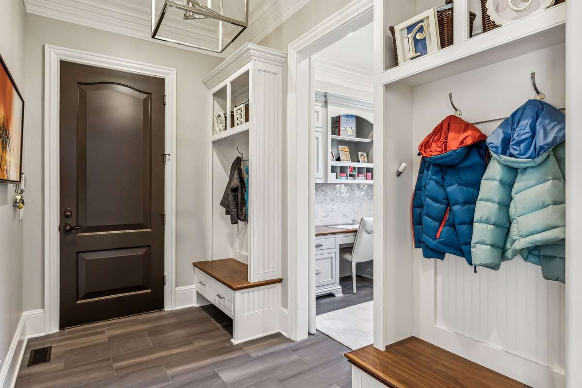 Conveniently located between the Kitchen & Garage, the Drop Zone blends function & style. A newly installed sliding barn door maximizes usable space, while two sets of custom cubbies w/hooks provide the perfect spot to keep bags &jackets organized.