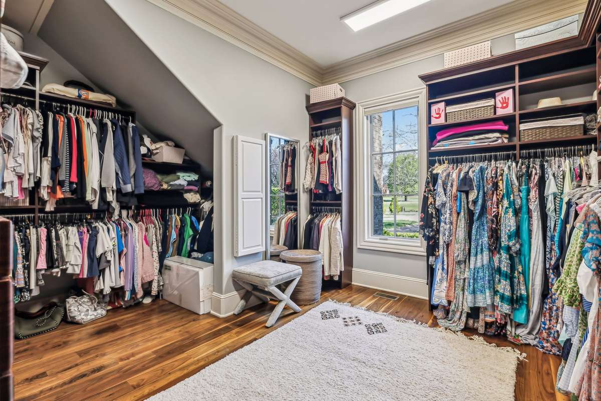 Two spacious Primary Closets simplify your morning routine with built-in shelving, soft-close drawers, ample shoe storage, and a convenient pull-down ironing board, ensuring everything you need is perfectly organized and within reach.