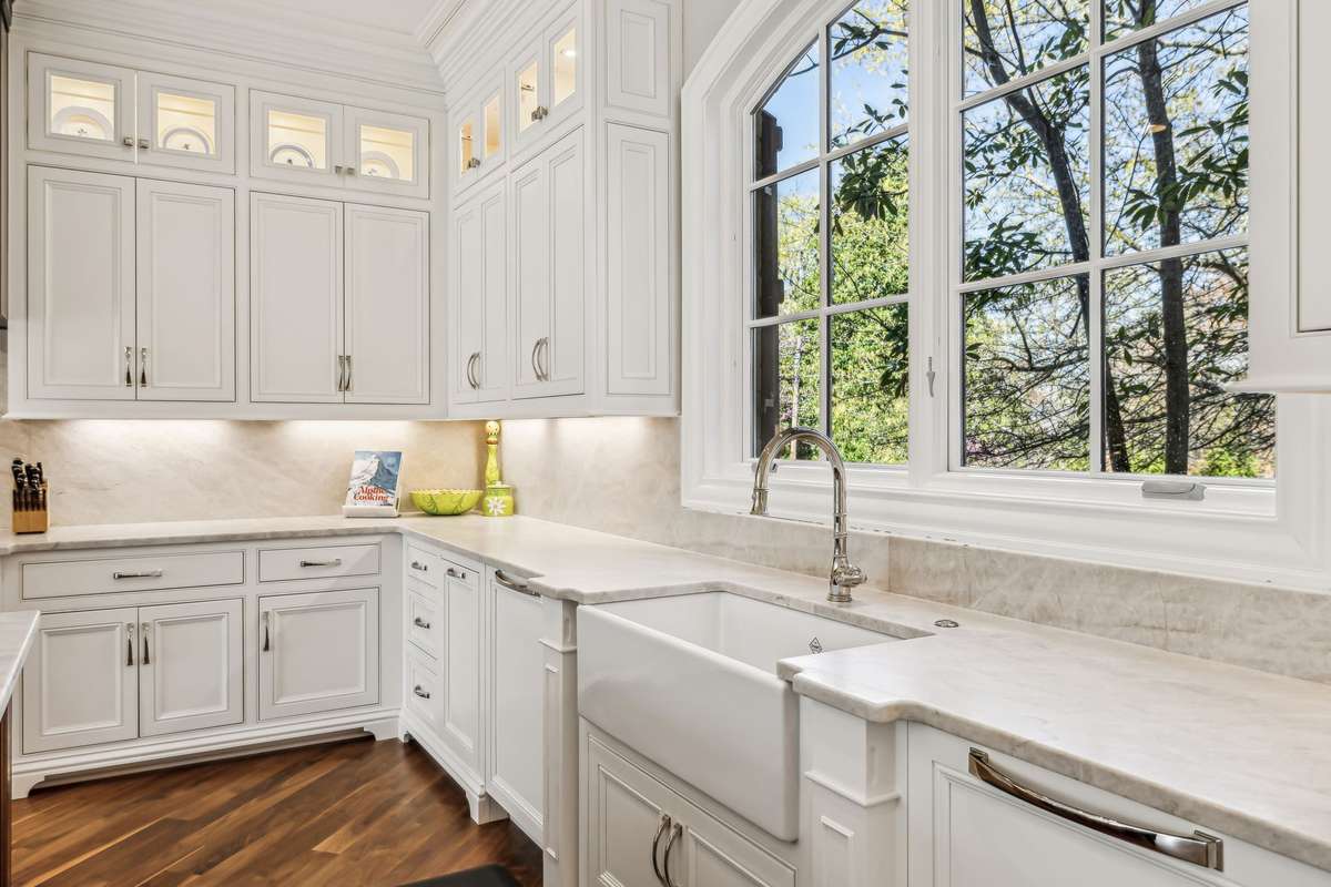 Two Scotsman ice makers—one for nugget ice and one for large gourmet cubes. A large Shaws farmhouse sink, Rohl faucets, a pot filler, and under-cabinet lighting and glass-front cabinets with interior lighting showcase your finest pieces.