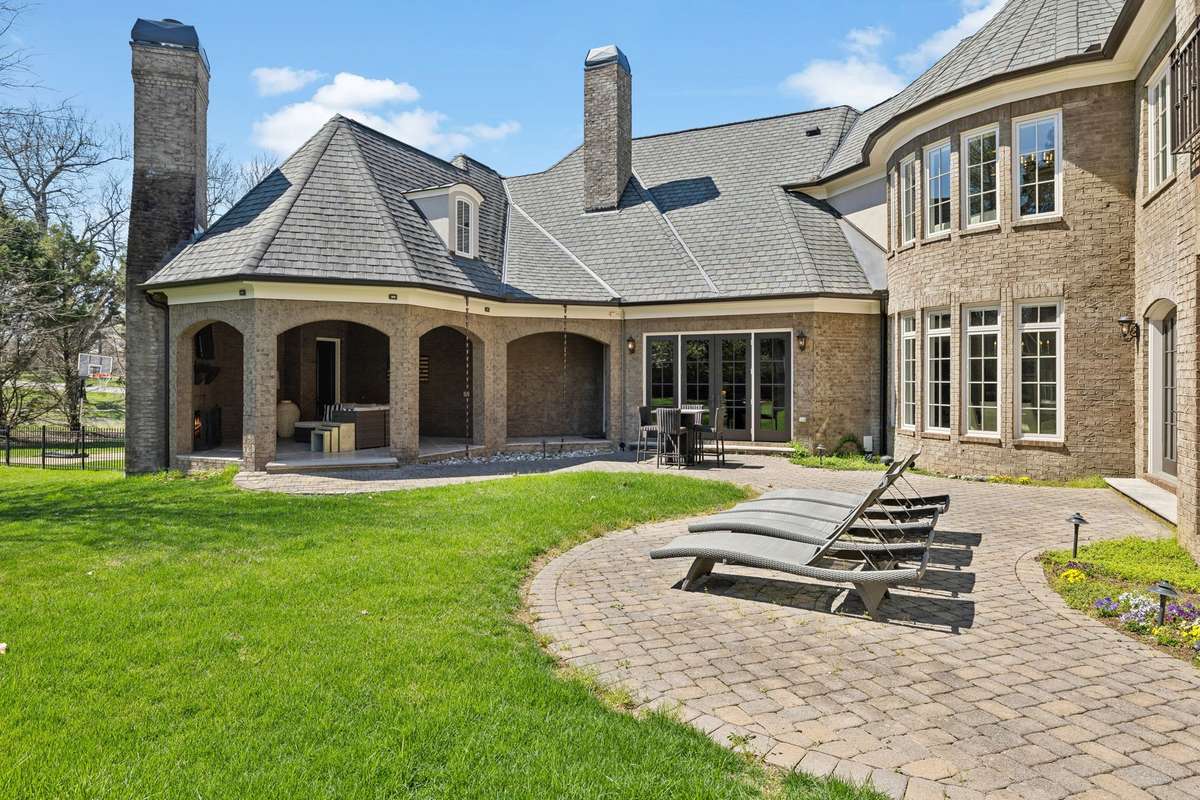 A built-in landscape audio system with four speakers and a subwoofer brings music to life, and landscape lighting casts a soft glow as the evening falls. Several seating areas invite you to unwind and enjoy the peaceful beauty of your surroundings.