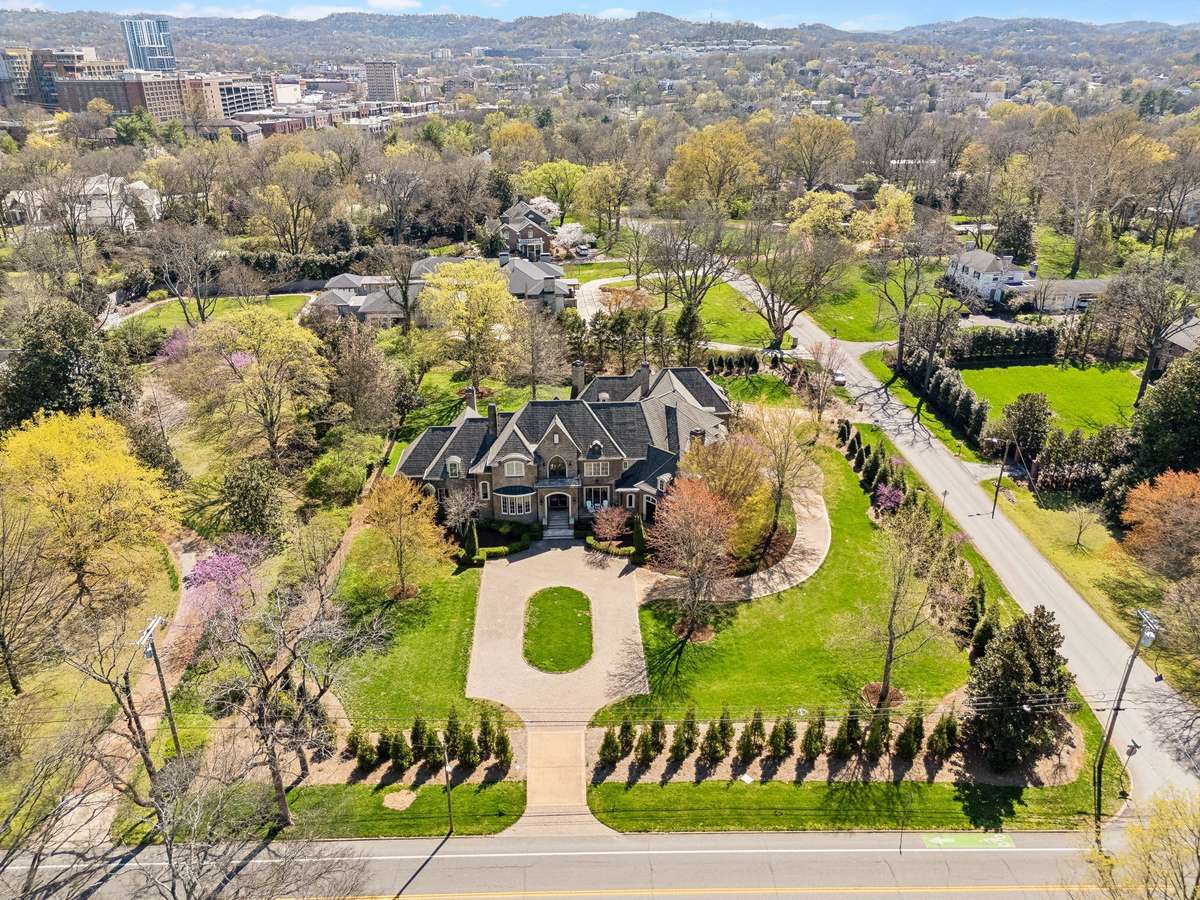 The side driveway entrance leads to a spacious 4-car garage and a welcoming friends' entry, adding both convenience and charm. The property has been thoughtfully enhanced with 62 trees and 179 plants, creating a natural barrier and ensuring privacy.
