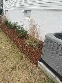 Detail of landscaping. Home has been landscaped, sod, mulch and new circular drive have been added.