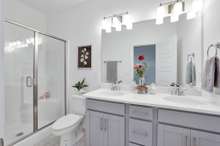 Primary Ensuite Bath. The home under construction will have a tub/shower combo in primary bath. The home featured in these photos is similar to the one under construction.  Selections and other features may vary.