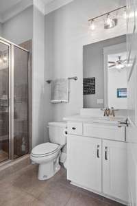 This full bath services the guest bedroom on the main level and has a tiled floor/shower. 36 inch vanity with a quartz counter top and glass shower door.