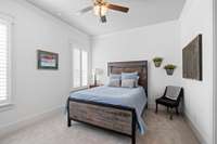 The guest bedroom on the main has its own private bath access and solid plantation shutters. It makes for a fabulous guest bedroom as it sits away from the other bedrooms in the house or an in-law suite.