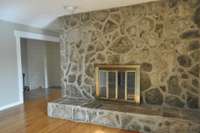 Spacious living room with beautiful views of the large stone fireplace!