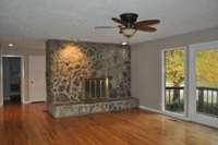 Spacious living room with beautiful views of the large stone fireplace!